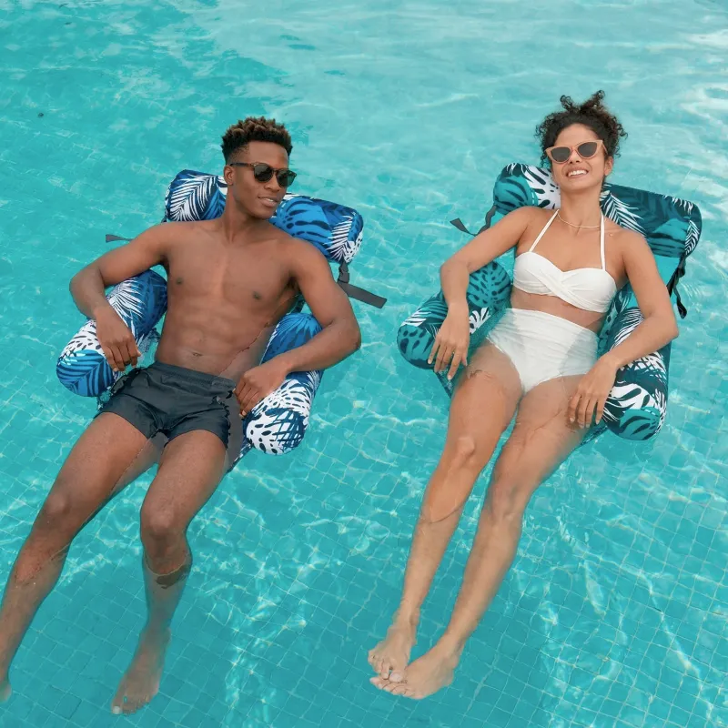 Person reclining on an inflatable floating chair in a pool