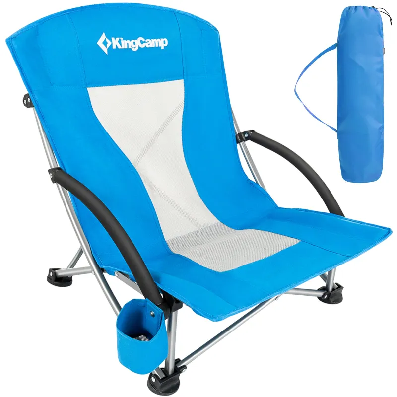 KingCamp folding beach chair open and positioned on a sandy beach
