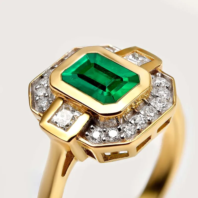 Rachel Galley emerald halo ring with center stone framed by halo setting
